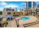 Beautiful outdoor pool with lounge chairs, umbrellas, and a nice view of the city skyline at 151 E Washington St # 419, Orlando, FL 32801