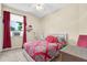 Bright bedroom with red and black accents and patterned bedding, creating a vibrant and inviting space at 158 Cedar Springs Cir, Debary, FL 32713