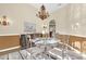 Formal dining room featuring a chandelier, buffet, and round glass-top table at 158 Cedar Springs Cir, Debary, FL 32713