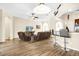 Bright, open-concept living area with wood floors and bar seating adjacent to the kitchen at 158 Cedar Springs Cir, Debary, FL 32713