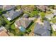 An aerial view of a house with a screened-in pool, manicured yard, and a brick driveway, surrounded by green foliage at 1649 Kersley Cir, Lake Mary, FL 32746