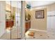 Bright bathroom featuring granite counters, wood cabinets, tile floors, and a mirror that enhances the sense of space at 1649 Kersley Cir, Lake Mary, FL 32746