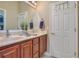 Bathroom featuring double sinks, wood cabinets, and a large mirror at 1649 Kersley Cir, Lake Mary, FL 32746