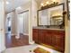 Well-lit bathroom featuring wood cabinets and a granite countertop at 1649 Kersley Cir, Lake Mary, FL 32746