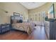 Bright bedroom featuring hardwood floors, neutral paint, and lots of natural light from the many windows at 1649 Kersley Cir, Lake Mary, FL 32746