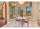 Bright breakfast nook featuring a round table and windows overlooking a screened-in pool at 1649 Kersley Cir, Lake Mary, FL 32746