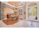 Elegant dining area featuring light tile floors, glass table, and a stone accent wall at 1649 Kersley Cir, Lake Mary, FL 32746