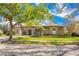 Charming home featuring stone accents, a well-manicured lawn, and mature trees offering curb appeal at 1649 Kersley Cir, Lake Mary, FL 32746