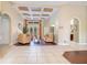 A sunny living room with high ceilings, archways, french doors, and a beautiful tile and wood floor at 1649 Kersley Cir, Lake Mary, FL 32746