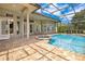 Beautiful pool area with a spa, screened enclosure, and a brick paver patio at 1649 Kersley Cir, Lake Mary, FL 32746