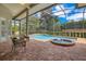 Inviting screened-in pool and spa surrounded by a brick paver patio and lush landscaping at 1649 Kersley Cir, Lake Mary, FL 32746