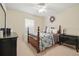 Relaxing bedroom featuring a patterned comforter, side tables, and a ceiling fan at 1740 Efland Ter, Deltona, FL 32738