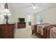 Comfortable bedroom featuring a dresser, television, and a view into the bathroom at 1740 Efland Ter, Deltona, FL 32738