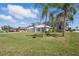 Charming single-story home features a new metal roof, well-manicured lawn, and is framed by mature palm trees at 1740 Efland Ter, Deltona, FL 32738