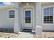 Charming front entry with decorative columns and glass storm door at 1740 Efland Ter, Deltona, FL 32738