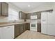 A well-lit kitchen showcases stainless steel appliances, mocha cabinets, and light countertops at 1740 Efland Ter, Deltona, FL 32738