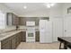 Well-lit kitchen featuring stainless steel appliances, tile flooring, and neutral cabinets at 1740 Efland Ter, Deltona, FL 32738