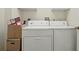 Neat laundry area with stacked boxes and appliances, maximizing space and functionality at 1740 Efland Ter, Deltona, FL 32738