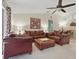 Cozy living room with leather furniture, ceiling fan, and neutral color palette at 1740 Efland Ter, Deltona, FL 32738