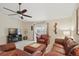 Comfortable living room featuring a ceiling fan, sliding glass doors to the exterior, and cozy furniture at 1740 Efland Ter, Deltona, FL 32738