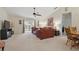 Spacious living room featuring leather furniture, ceiling fan, and sliding glass door to lanai at 1740 Efland Ter, Deltona, FL 32738