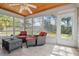 Bright sunroom with tiled floors, many windows and wicker furniture at 1740 Efland Ter, Deltona, FL 32738