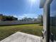 View of fenced backyard with concrete slab at 1825 Cayman Cove Cir, St Cloud, FL 34772