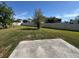 Large backyard with mature tree and white vinyl fence at 1825 Cayman Cove Cir, St Cloud, FL 34772