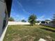 Spacious backyard featuring a mature tree and a white fence at 1825 Cayman Cove Cir, St Cloud, FL 34772