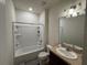 Bathroom featuring a tub, toilet, and single sink with a shower at 1825 Cayman Cove Cir, St Cloud, FL 34772