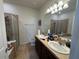 Bathroom featuring double sinks with modern fixtures and a glass shower at 1825 Cayman Cove Cir, St Cloud, FL 34772