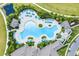 Aerial view of the community pool area, highlighting the ample seating, lush landscaping, and inviting atmosphere at 18381 Oliver Twist Way, Winter Garden, FL 34787
