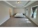 Spacious bedroom featuring tray ceilings and neutral walls, filled with natural light at 18381 Oliver Twist Way, Winter Garden, FL 34787