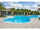 Resort-style community pool with ample seating, palm trees, and lounge chairs, perfect for relaxing or socializing with neighbors at 18381 Oliver Twist Way, Winter Garden, FL 34787