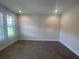 Empty living room featuring wood-look flooring and a window offering natural light at 18381 Oliver Twist Way, Winter Garden, FL 34787