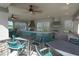 Outdoor kitchen featuring stainless steel appliances, tiled backsplash, and ceiling fans for comfort at 18381 Oliver Twist Way, Winter Garden, FL 34787