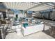 Inviting outdoor seating beneath a pergola with comfortable furniture and stylish decor at 18381 Oliver Twist Way, Winter Garden, FL 34787