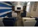 Comfortable sitting area offering plush seating, a mounted television, and elegant decor at 18381 Oliver Twist Way, Winter Garden, FL 34787