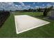 Outdoor sand volleyball court for residents, perfect for recreation with lush green grass and the lake in the background at 18381 Oliver Twist Way, Winter Garden, FL 34787