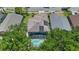 Aerial view of the home and pool, surrounded by mature trees at 2204 Hammock Moss Dr, Orlando, FL 32820