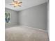 Inviting bedroom features a large window and neutral-toned walls and carpet flooring for a calm atmosphere at 2204 Hammock Moss Dr, Orlando, FL 32820