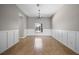 Inviting dining room with classic wainscoting and a chandelier at 2204 Hammock Moss Dr, Orlando, FL 32820