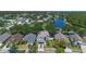Wide aerial view of a well-landscaped house, neighborhood, and a lake at 2204 Hammock Moss Dr, Orlando, FL 32820