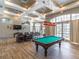 Spacious game room featuring a pool table, beamed ceilings and ample seating at 2204 Hammock Moss Dr, Orlando, FL 32820