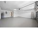Spacious garage with painted walls and floors, utility closet, and garage door with automated opener at 2204 Hammock Moss Dr, Orlando, FL 32820