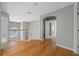 Open hallway with hardwood floors leads to staircase and rooms filled with natural light at 2204 Hammock Moss Dr, Orlando, FL 32820