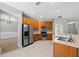 Well-equipped kitchen with stainless steel appliances, wood cabinets, tile backsplash, and ample counter space at 2204 Hammock Moss Dr, Orlando, FL 32820