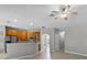 Well-lit kitchen with wood cabinetry, stainless steel appliances, and breakfast bar, perfect for casual dining at 2204 Hammock Moss Dr, Orlando, FL 32820