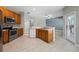 Oak kitchen with stainless steel appliances, breakfast bar, and tile flooring; stylish and functional at 2204 Hammock Moss Dr, Orlando, FL 32820