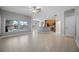 Bright living room featuring tile floors, a ceiling fan, and views of the pool area at 2204 Hammock Moss Dr, Orlando, FL 32820